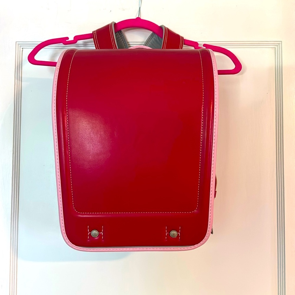 Red Japanese School Bag with pink trim and reflective stripes.